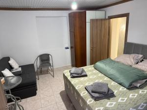 a bedroom with a bed and a chair in it at Villa Maria in Mángana