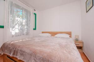 a bedroom with a large bed and a window at House Punta in Kraj