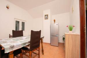 a kitchen with a table and a refrigerator at House Punta in Kraj