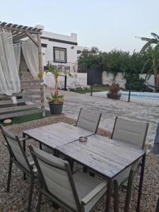 a wooden table and chairs in a yard at LA BRISA in Cádiz