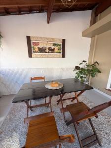 a table and chairs in a room with a painting on the wall at Sobrado completo, confortável e bem localizado in Santo André