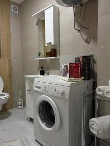 a washer and dryer in a small bathroom at LUMA Campus Studio in Brčko +12 photos