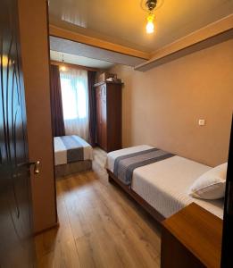 a hotel room with two beds and a window at Best apartment in Gonio