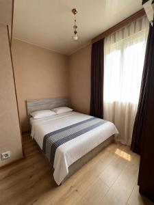 a bedroom with a large bed with a window at Best apartment in Gonio
