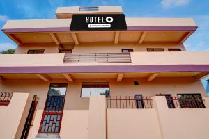 a building with a hotel sign on it at Super Hotel O Dharampur Crossway in Mājra +27 photos