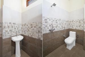 a bathroom with a toilet and a sink at Super Hotel O Dharampur Crossway in Mājra
