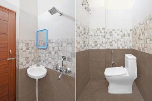a bathroom with a toilet and a sink at Super Hotel O Dharampur Crossway in Mājra