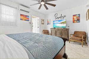a bedroom with a bed and a flat screen tv at Sailors Cabin - Prime Downtown Key West Spot - Walk to Duval in Key West