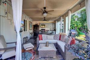 a living room with a couch and a table at Caribbean Paradise Retreat Private Pool, Outdoor Kitchen & Jacuzzi in Fort Lauderdale