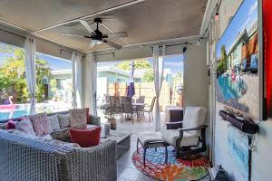 a screened in porch with a couch and chairs at Caribbean Paradise Retreat Private Pool, Outdoor Kitchen & Jacuzzi in Fort Lauderdale