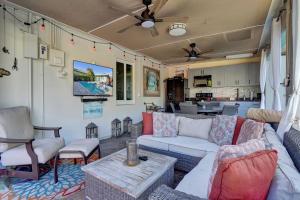 a living room with a couch and chairs and a kitchen at Caribbean Paradise Retreat Private Pool, Outdoor Kitchen & Jacuzzi in Fort Lauderdale