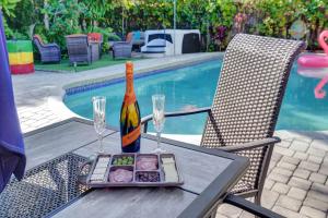 a bottle of champagne and a plate of food on a table at Caribbean Paradise Retreat Private Pool, Outdoor Kitchen & Jacuzzi in Fort Lauderdale +41 photos