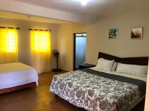 a bedroom with a large bed and a window at Rancho La Cueva in Miches