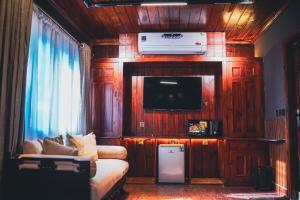 a living room with a couch and a television at Valea Bhurban in Bhurban