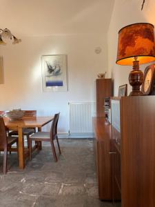 a dining room with a table and a lamp at Casa Kaikos in Sevastí