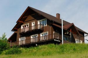 a large wooden house with balconies on a hill at Мелодія Гір Вид на гори in Vorokhta