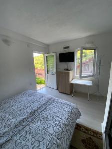 a bedroom with a bed and a flat screen tv at Villa D&M in Ohrid