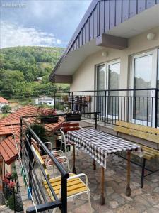 a balcony with a table and benches on a house at Villa D&M in Ohrid