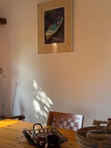 a dining room table with a picture of a boat on the wall at Casa Kaikos in Sevastí