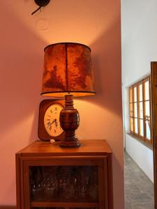 a lamp on a table with a clock on it at Casa Kaikos in Sevastí +73 photos
