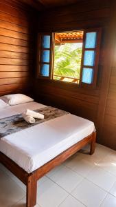a bedroom with two beds and a window at Pousada Jangá Jeri in Jericoacoara +17 photos