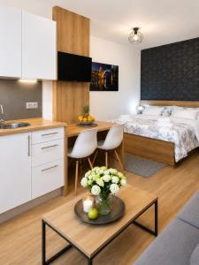 a room with a bed and a table with flowers at Villa Diamond in Mostar