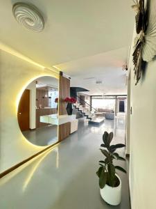 a living room with a round mirror and a plant at Hostal Casa Iwa in Medellín