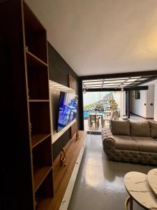 a living room with a couch and a television at Hostal Casa Iwa in Medellín
