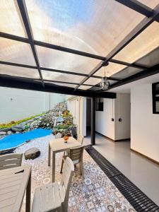 a living room with a table and a view of the ocean at Hostal Casa Iwa in Medellín