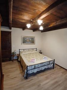 a bedroom with a bed and a wooden ceiling at Eva house 1 in Fanano