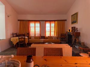 a living room with a couch and a table at Casa Kaikos in Sevastí