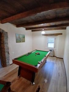 a room with a pool table in a room at Eva house 1 in Fanano