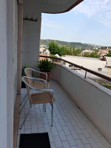 two chairs sitting on a balcony with a view at Apartamento Milo in Loures