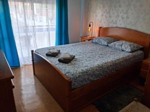a bedroom with a bed with shoes on it at Apartamento Milo in Loures