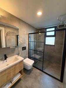 a bathroom with a shower and a sink and a toilet at North Star Resort Hotel in Of +71 photos