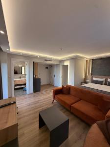 a living room with a couch and a bed at North Star Resort Hotel in Of
