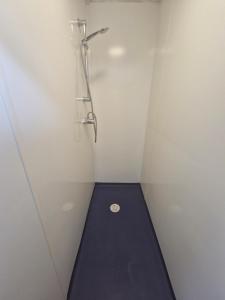 a shower stall with a black floor in a white room at Ty Bert in Newport +18 photos