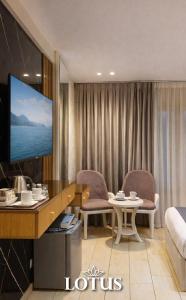 a hotel room with a bed and a table and chairs at Lotus Hotel l Downtown Cairo Sq in Cairo