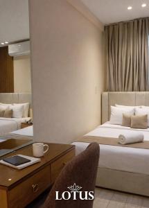 a hotel room with two beds and a mirror at Lotus Hotel l Downtown Cairo Sq in Cairo