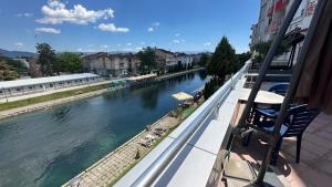 a view of a river from a balcony at Riverside Apartment in Struga +8 photos