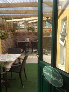 a restaurant with a patio with tables and chairs at The Old Medical Hall in Castletownbere