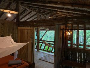 an inside view of a wooden cabin with a hammock at Maskani Wasi in Lago Agrio