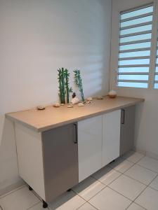 a kitchen island with a wooden counter top in a room at Jolie maison avec terrasse in Partarieux