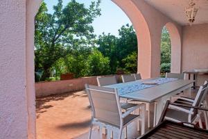 a patio with a table and chairs on a patio at Villa Ontanelli - 500mt dal mare in Marciana Marina