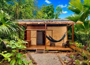 a hammock in front of a tiny house at Casa Caimito in Nuquí +59 photos