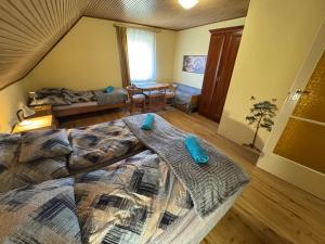 a bedroom with a bed with blue pillows on it at Manna Igal Apartman in Igal +41 photos
