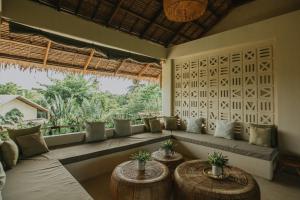 a living room with a couch and two tables at Schönhouse Villa Siargao in General Luna