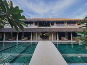 a villa with a swimming pool in front of it at Schönhouse Villa Siargao in General Luna