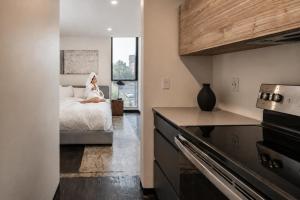a woman sitting on a bed in a bedroom at Ida Phoenix in Phoenix +22 photos