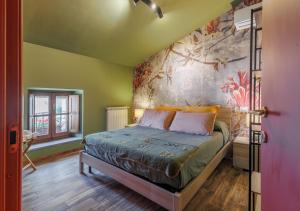 a bedroom with a bed with a painting on the wall at B&B Locanda Cistercense in San Martino al Cimino
